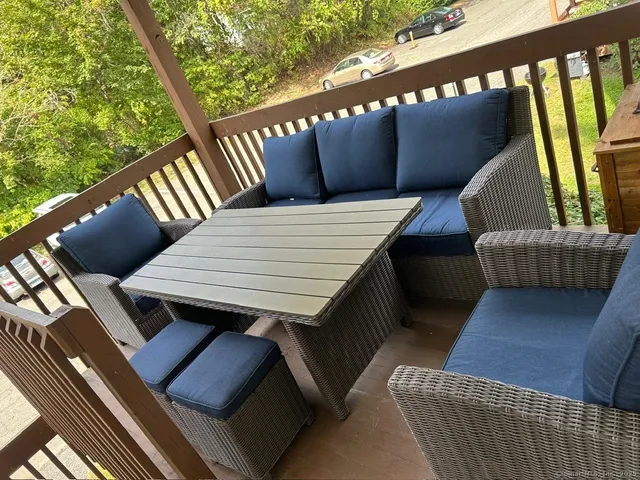 a balcony view with a seating space