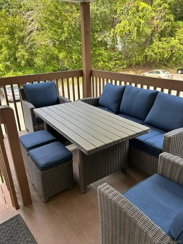 a balcony view with a seating space