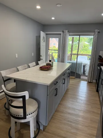 a kitchen with a sink stove and wooden floor