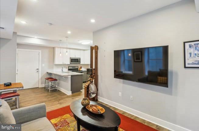 1340 Nicholson Street Northwest, Unit 2 Washington, DC 20011 - Photo 13 of 31 a living room with furniture and a flat screen tv