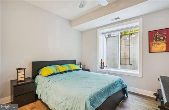 1340 Nicholson Street Northwest, Unit 2 Washington, DC 20011 - Photo 16 of 31 a bedroom with a bed and wooden floor