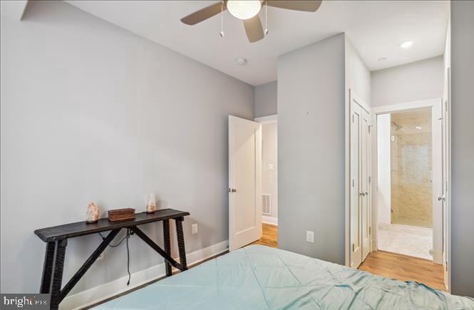 1340 Nicholson Street Northwest, Unit 2 Washington, DC 20011 - Photo 18 of 31 a bedroom with a bed and a chandelier fan