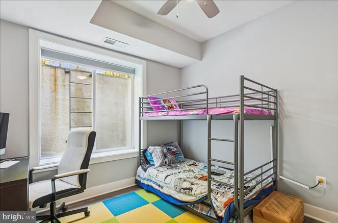 1340 Nicholson Street Northwest, Unit 2 Washington, DC 20011 - Photo 21 of 31 a bedroom with a bed and a chandelier