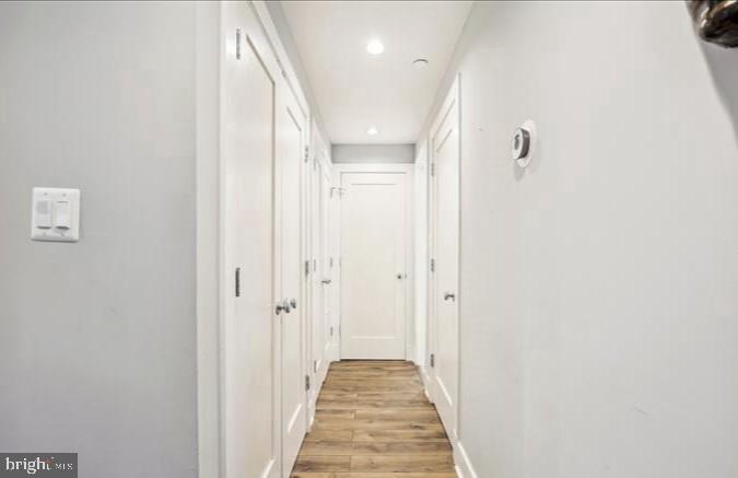 1340 Nicholson Street Northwest, Unit 2 Washington, DC 20011 - Photo 26 of 31 a view of a hallway with wooden floor and a bathroom