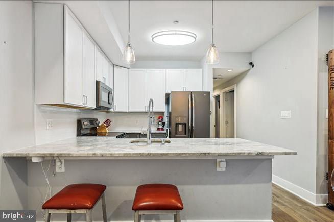 1340 Nicholson Street Northwest, Unit 2 Washington, DC 20011 - Photo 6 of 31 a kitchen with stainless steel appliances granite countertop a sink a refrigerator and a microwave