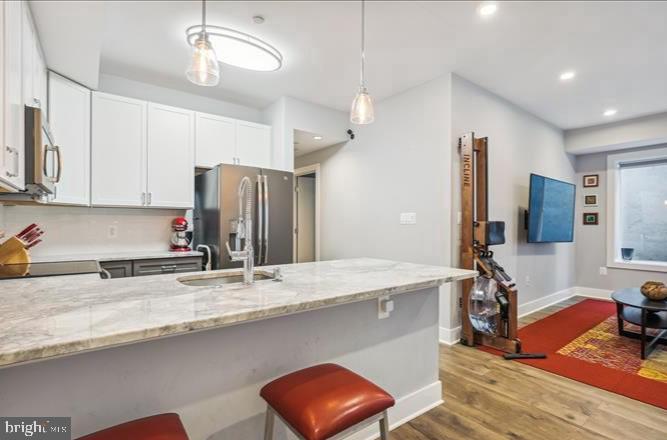 1340 Nicholson Street Northwest, Unit 2 Washington, DC 20011 - Photo 7 of 31 a kitchen with stainless steel appliances granite countertop a sink refrigerator and microwave