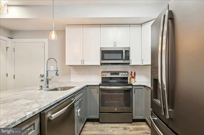 1340 Nicholson Street Northwest, Unit 2 Washington, DC 20011 - Photo 8 of 31 a kitchen with appliances a sink and cabinets
