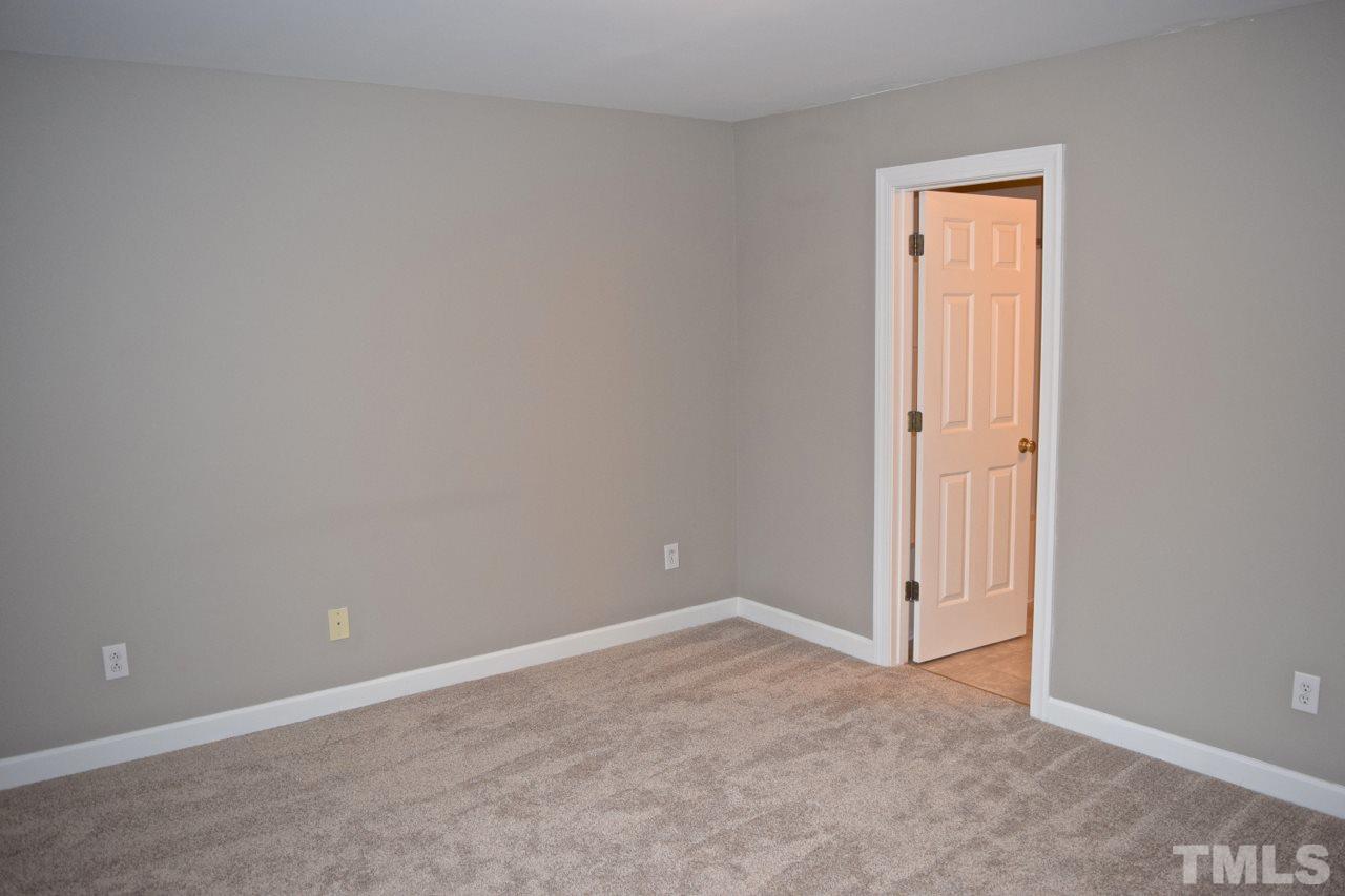 9106 Grassington Way Raleigh, NC 27615 - Photo 11 of 16 an empty room with closet and a window