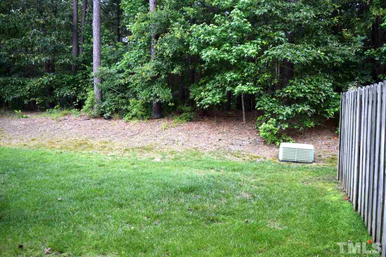 9106 Grassington Way Raleigh, NC 27615 - Photo 14 of 16 a view of backyard with green space