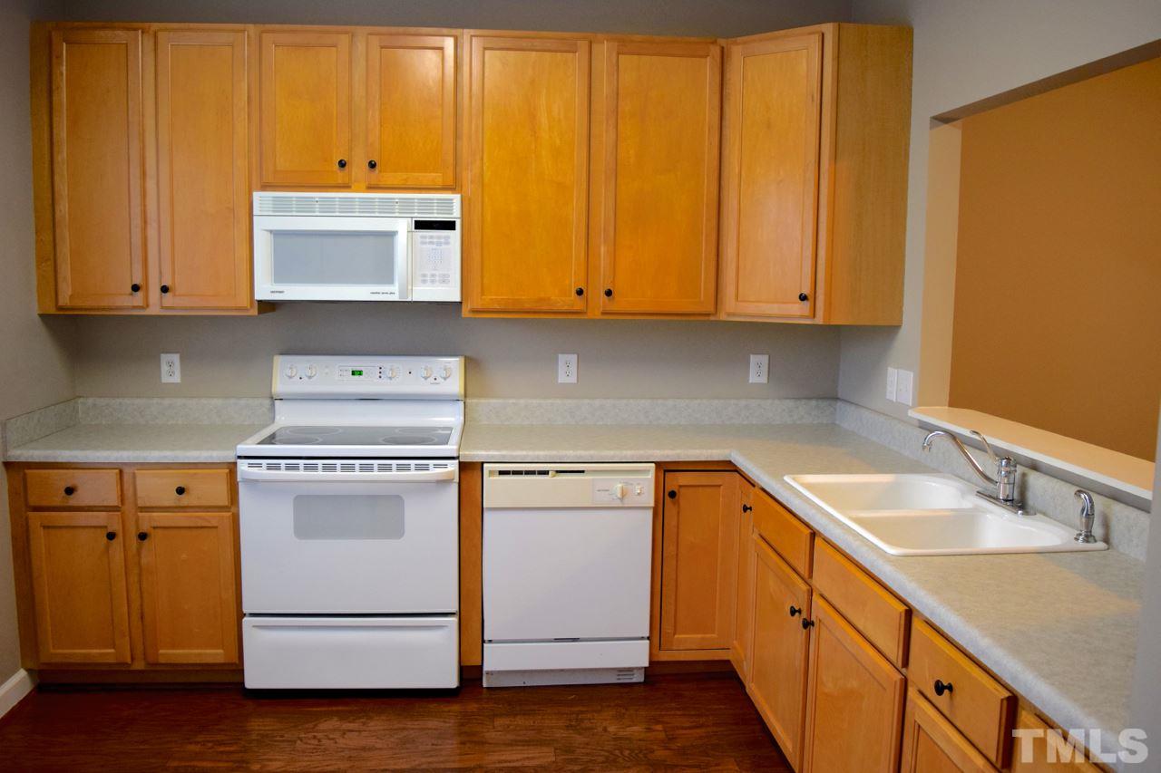 9106 Grassington Way Raleigh, NC 27615 - Photo 3 of 16 a kitchen with a sink and cabinets