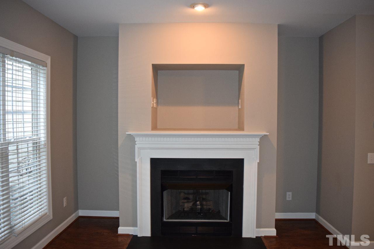 9106 Grassington Way Raleigh, NC 27615 - Photo 6 of 16 a white building with a fireplace