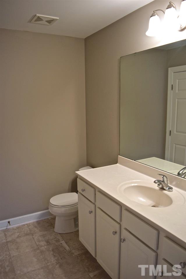 9106 Grassington Way Raleigh, NC 27615 - Photo 9 of 16 a bathroom with a sink a toilet