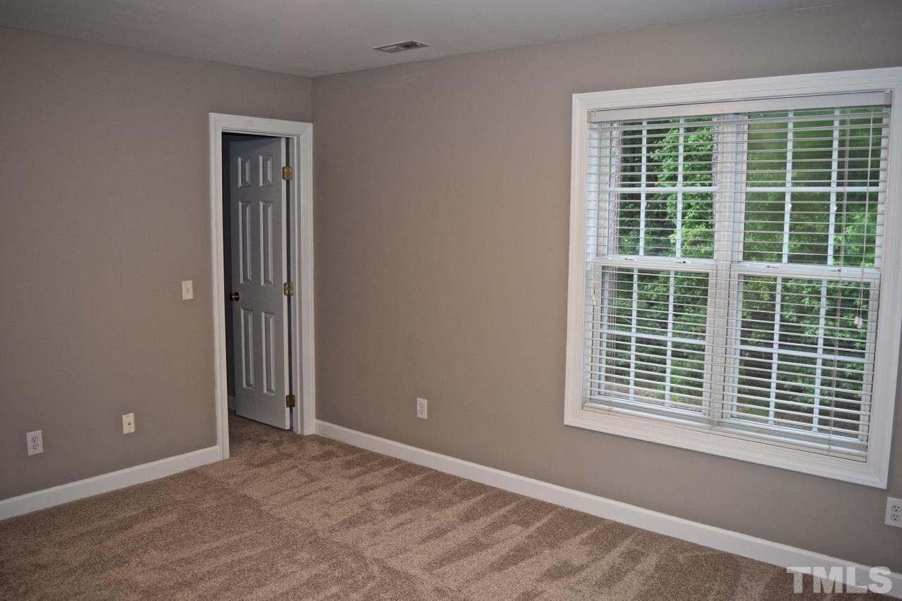 9106 Grassington Way Raleigh, NC 27615 - Photo 10 of 16 a view of an empty room with a window