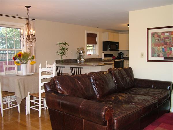 17 Argilla Road, Unit 5 Ipswich, MA 01938 - Photo 5 of 16 a living room with furniture a wooden floor and a flat screen tv