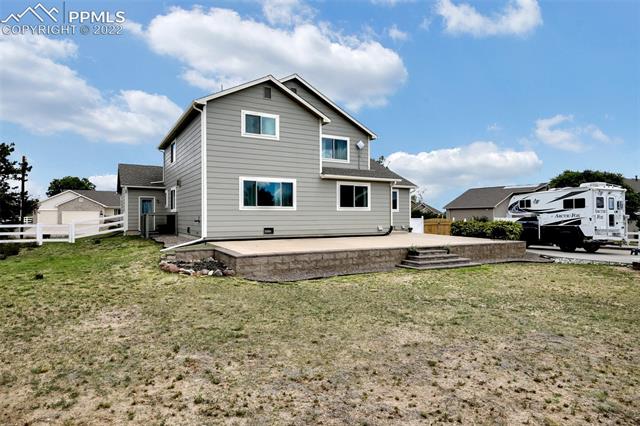 8460 Tibbs Road Peyton, CO 80831 - Photo 33 of 37 Rear of home w/Concrete patio the full width of the back of the home