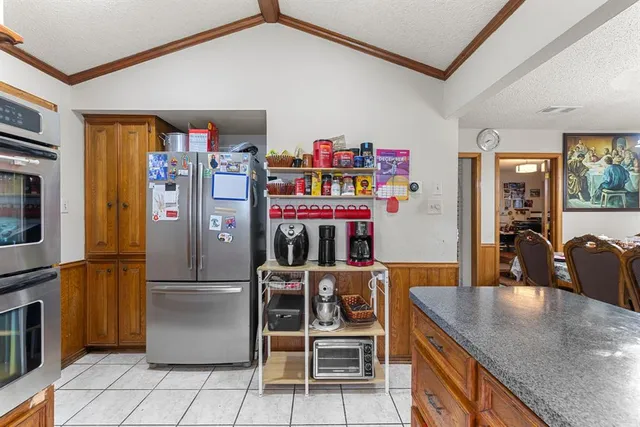 a kitchen with stainless steel appliances granite countertop a refrigerator and a sink