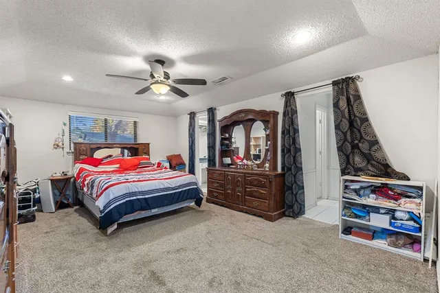 a bed room with a bed and a book shelf