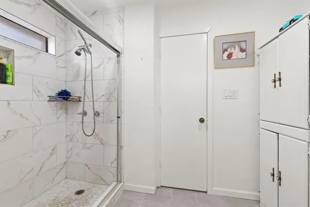 a bathroom with a shower and a sink