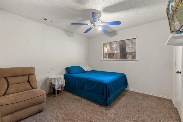 a living room with furniture and a ceiling fan