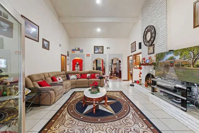 a living room with furniture a rug and a flat screen tv