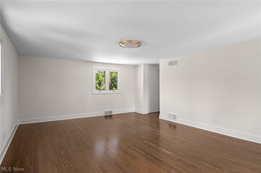 22625 Rye Road Shaker Heights, OH 44122 - Photo 28 of 38 Spacious room featuring wood-finish flooring, white walls, and a contemporary ceiling light fixture