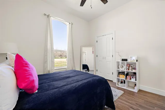 a bedroom with a bed and a window