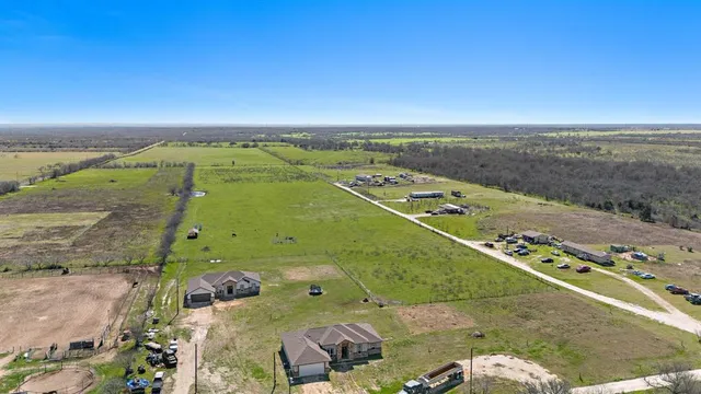 an aerial view of a residential houses with outdoor space