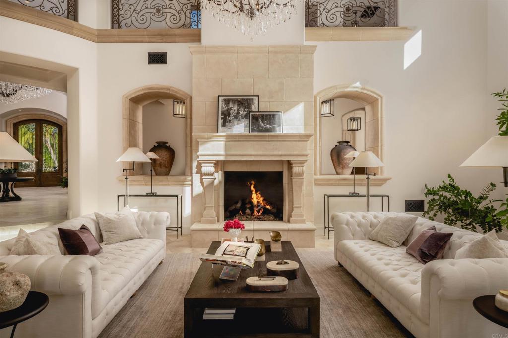 6853 Rancho Valencia Road Rancho Santa Fe, CA 92067 - Photo 4 of 29 a living room with furniture and a fireplace