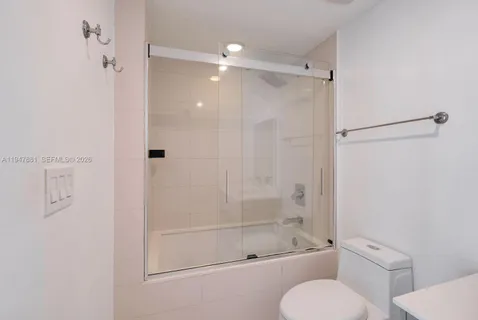 a bathroom with a shower and a toilet