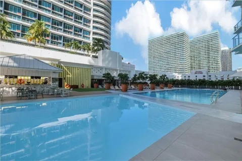 a swimming pool view with a outdoor seating