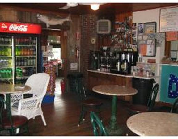 19 Main Street Little Compton, RI 02837 - Photo 18 of 25 a table and chairs in front of building