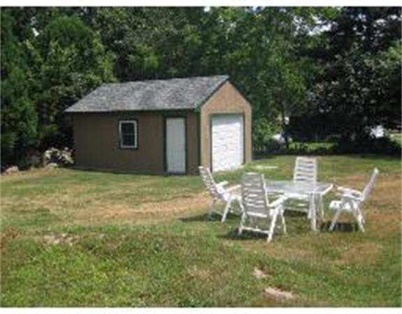 19 Main Street Little Compton, RI 02837 - Photo 5 of 25 a backyard of a house with table and chairs