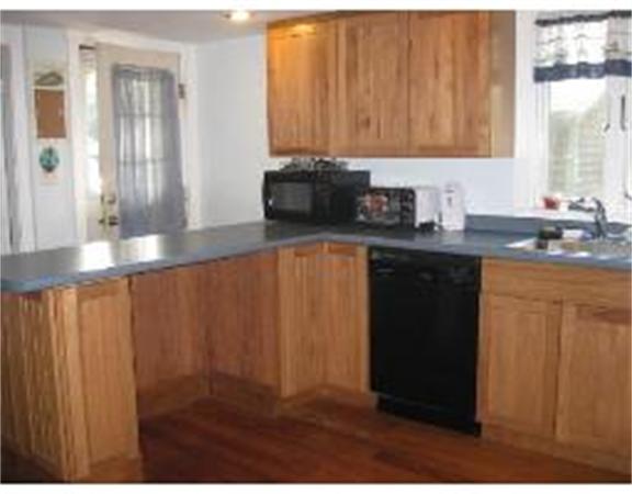 19 Main Street Little Compton, RI 02837 - Photo 8 of 25 a kitchen with a sink and cabinets
