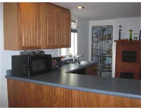 19 Main Street Little Compton, RI 02837 - Photo 9 of 25 a kitchen with a sink and cabinets