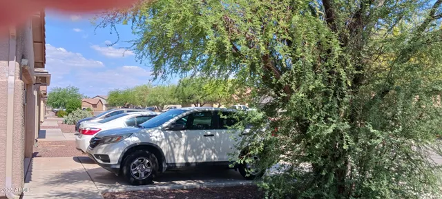 a view of a car in front of a building