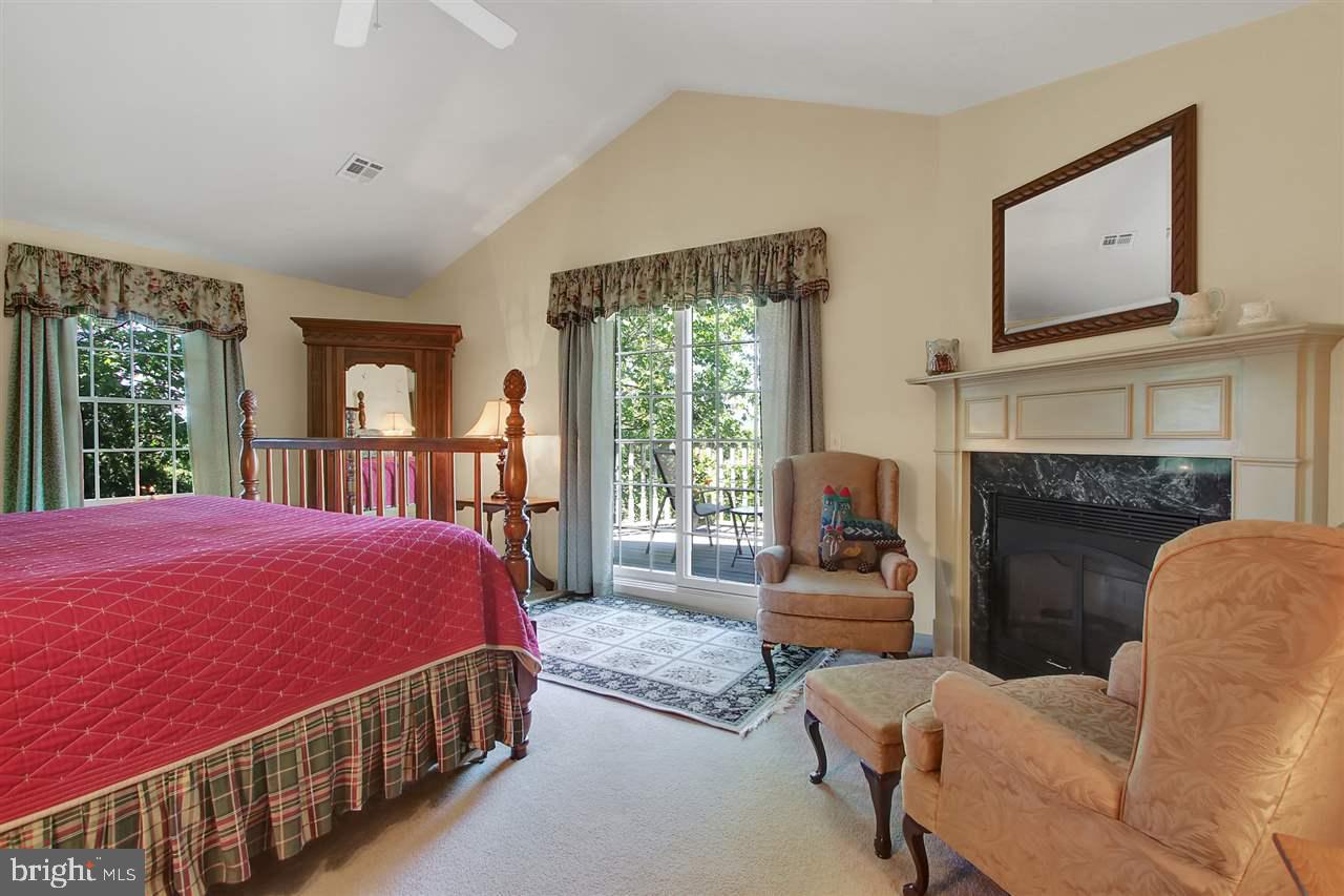 305 Crooked Creek Road Gettysburg, PA 17325 - Photo 19 of 36 a bedroom with a bed and a fireplace