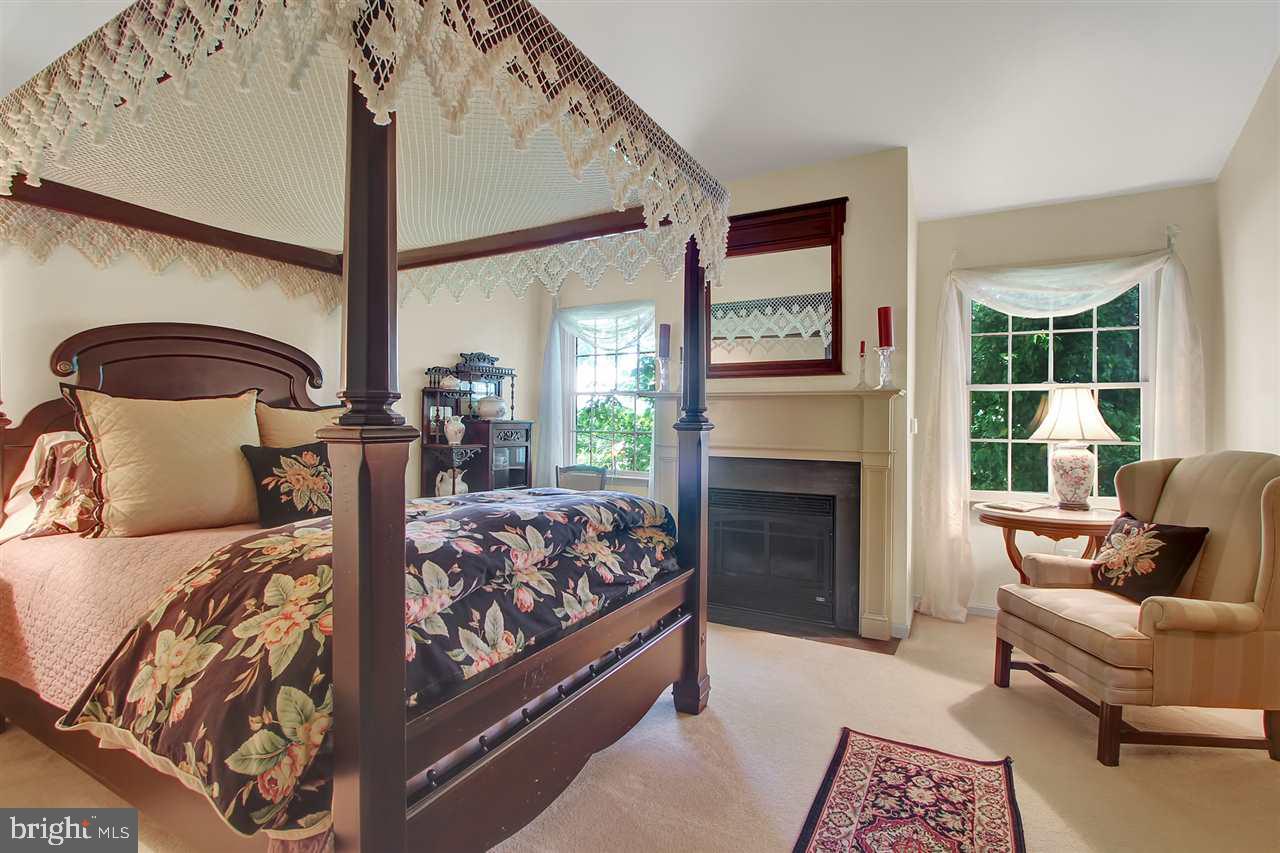 305 Crooked Creek Road Gettysburg, PA 17325 - Photo 21 of 36 a bed room with a bed and a fireplace
