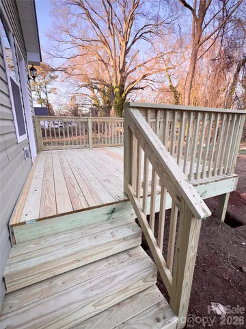 a view of wooden balcony with wooden floor and fence