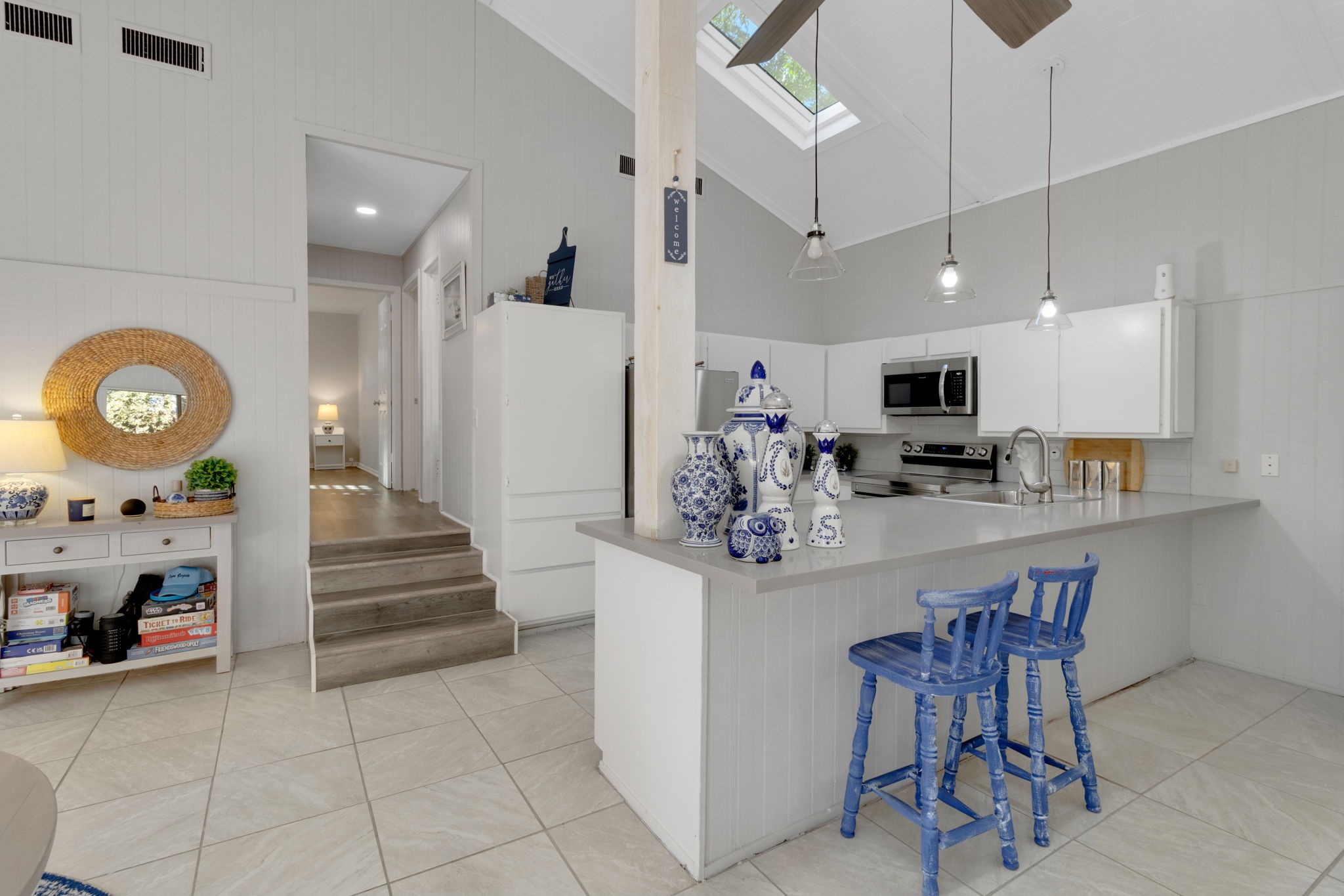 90 Harbour Lane Coldspring, TX 77331 - Photo 5 of 40 Kitchen with breakfast bar seating, pendant lighting, and direct access to the main living area.