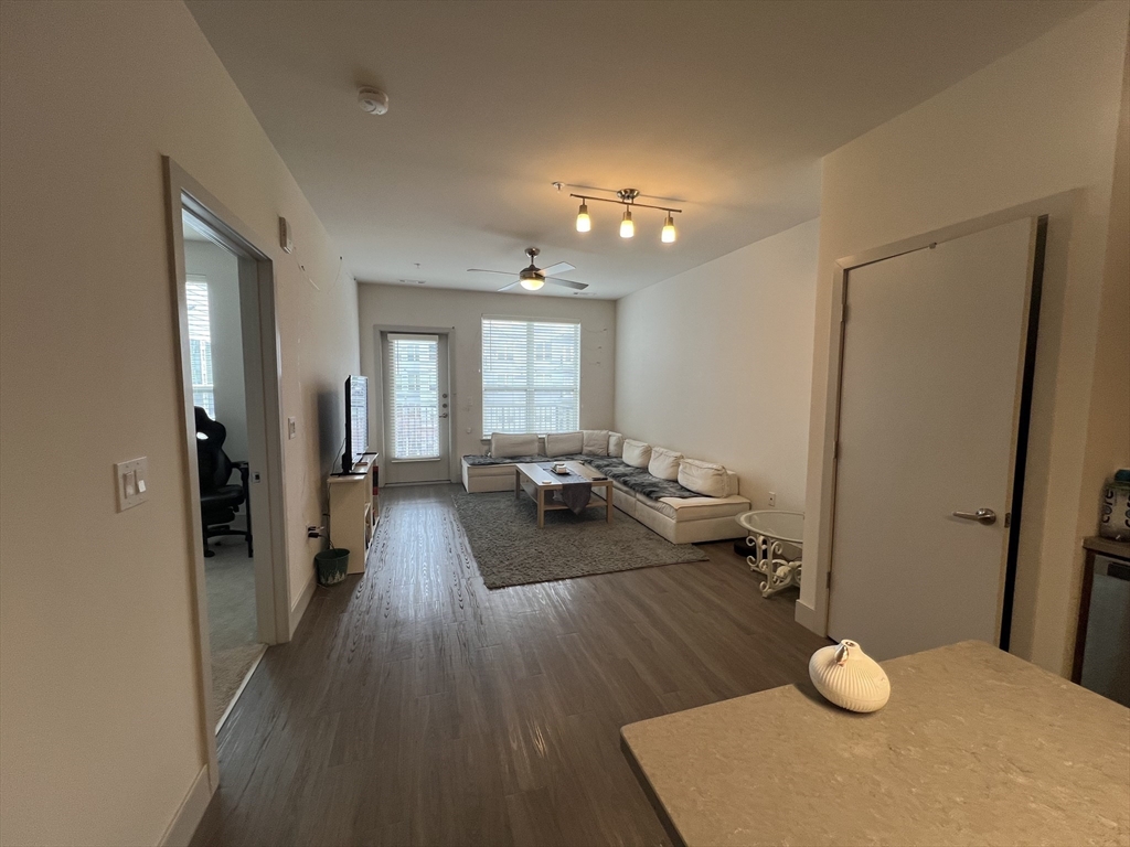255 Vale Street, Unit 5218 Chelsea, MA 02150 - Photo 4 of 9 a living room with furniture and wooden floor