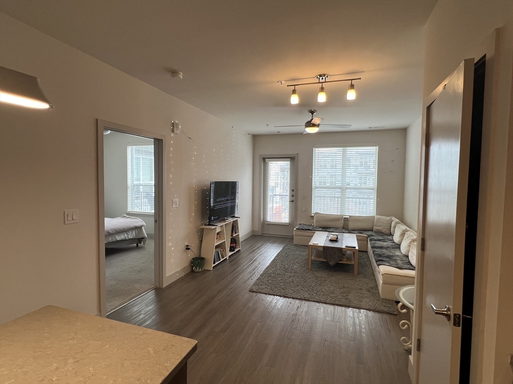 255 Vale Street, Unit 5218 Chelsea, MA 02150 - Photo 5 of 9 a living room with furniture and a flat screen tv
