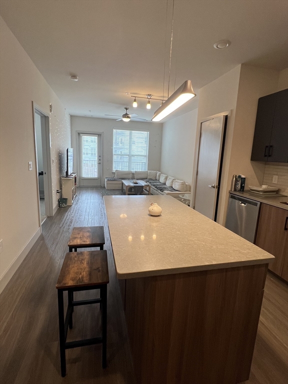 255 Vale Street, Unit 5218 Chelsea, MA 02150 - Photo 6 of 9 a large kitchen with sink a refrigerator and wooden floor
