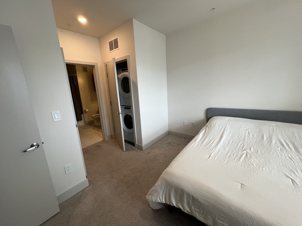255 Vale Street, Unit 5218 Chelsea, MA 02150 - Photo 9 of 9 a bed room with a bed and a walk in closet