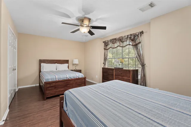 a bedroom with two large bed and a window