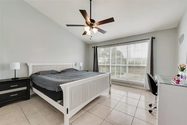 a bedroom with a bed and a large window