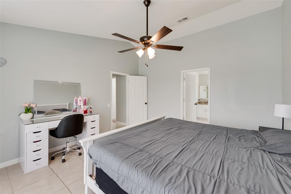 2629 Coldstream Drive Fort Worth, TX 76123 - Photo 21 of 24 a bedroom with a bed and a chandelier