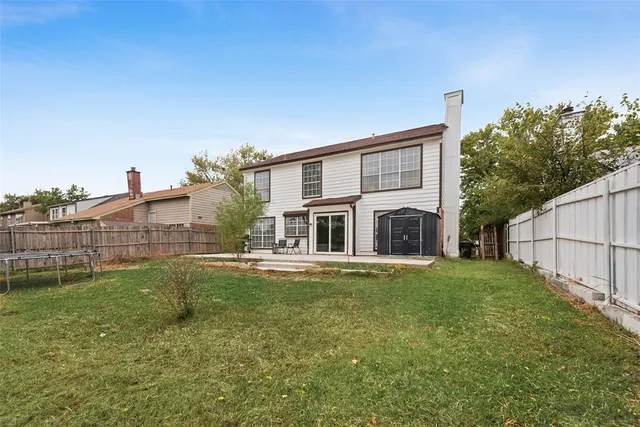 a view of a house with a yard and sitting area