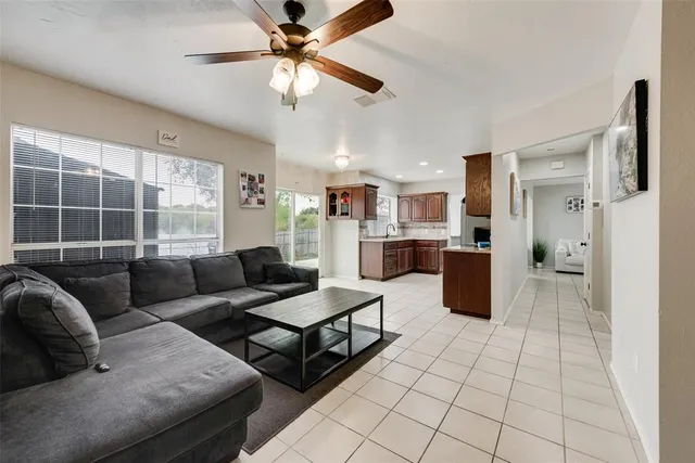 a living room with furniture and kitchen view