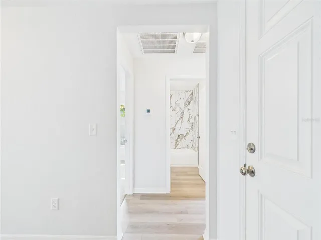 an empty room with closet and window
