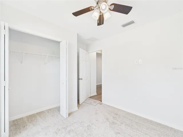 a bathroom with a granite countertop sink toilet a mirror a bathtub and shower